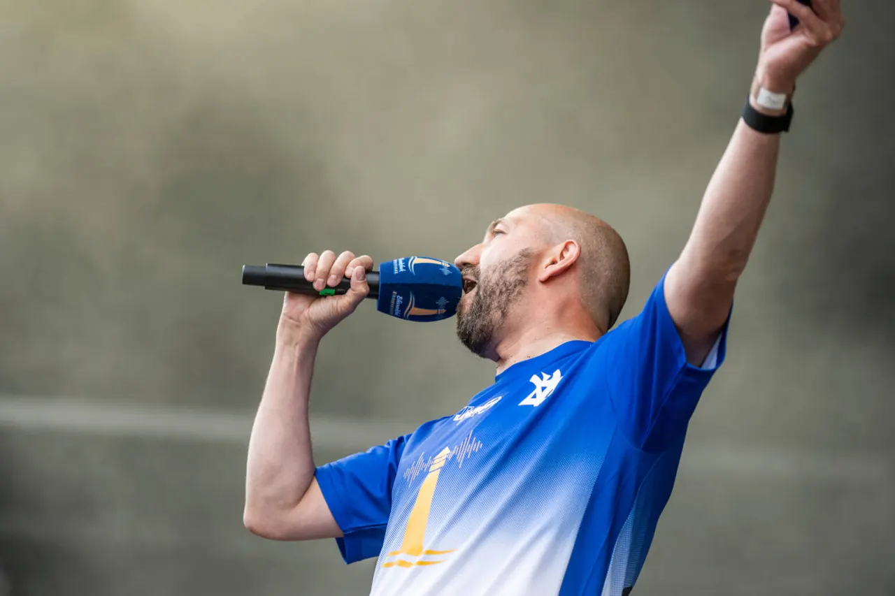 Sanger med mikrofon i blå trøje